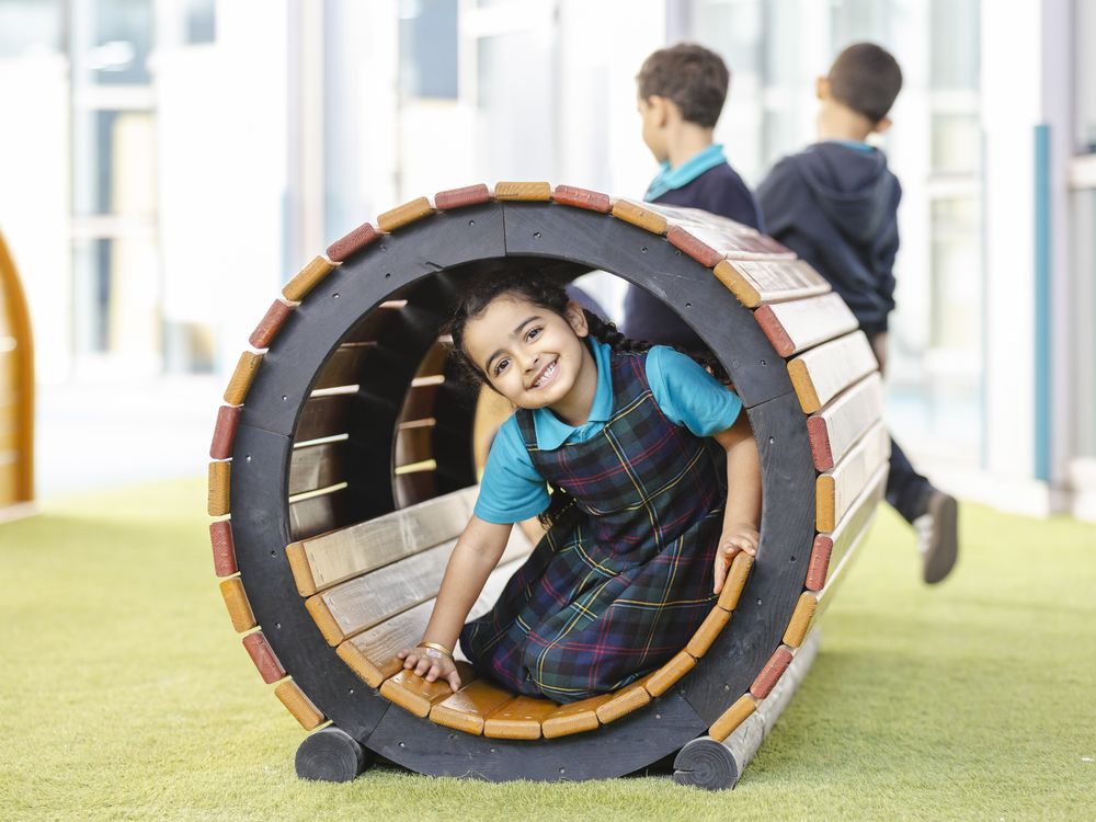 An Early Years pupil playing in the outdoor area