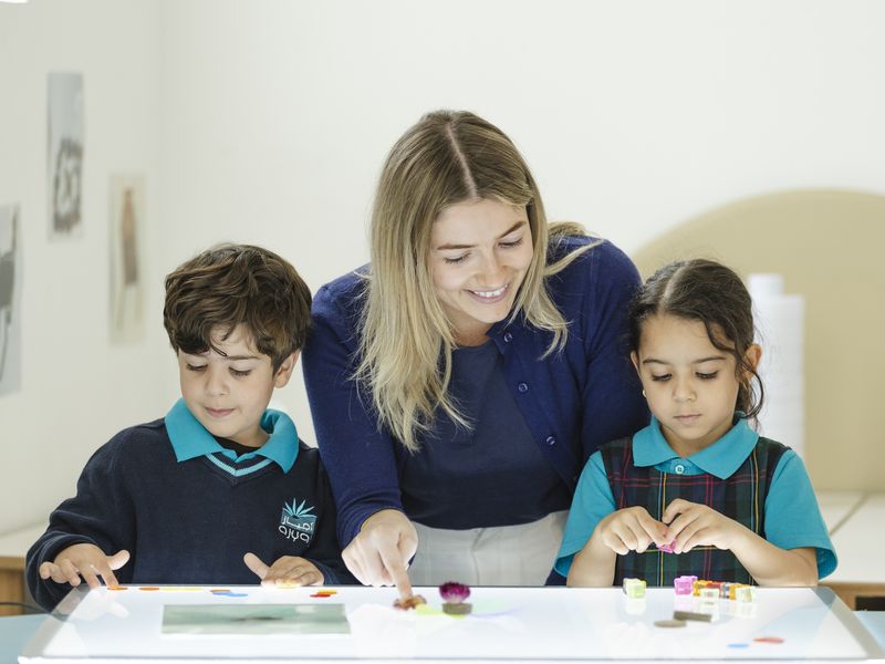 A teacher and pupils at the craft table