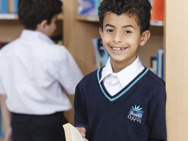 A pupil choosing a book in the library