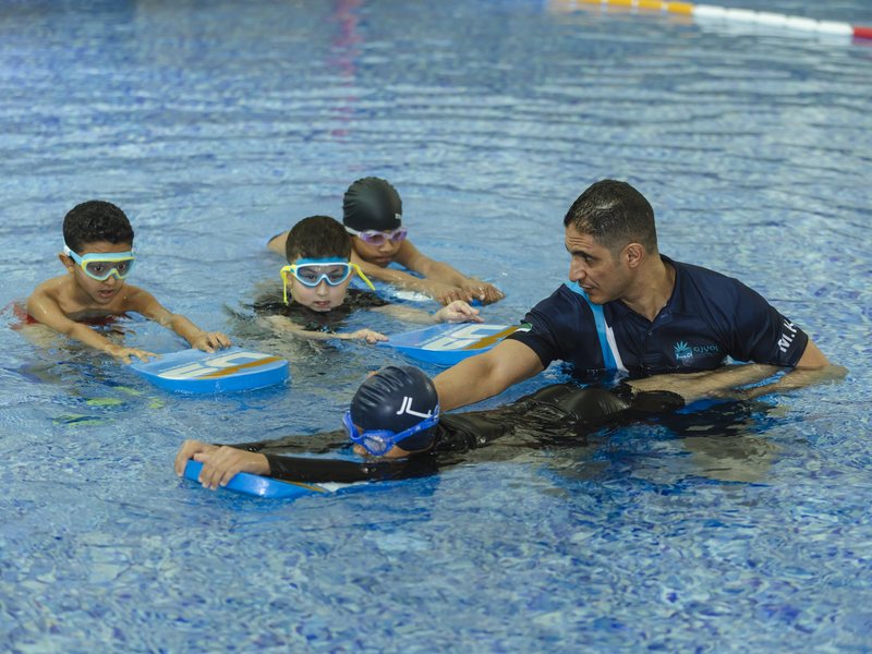 A pupil swimming in the indoor pool